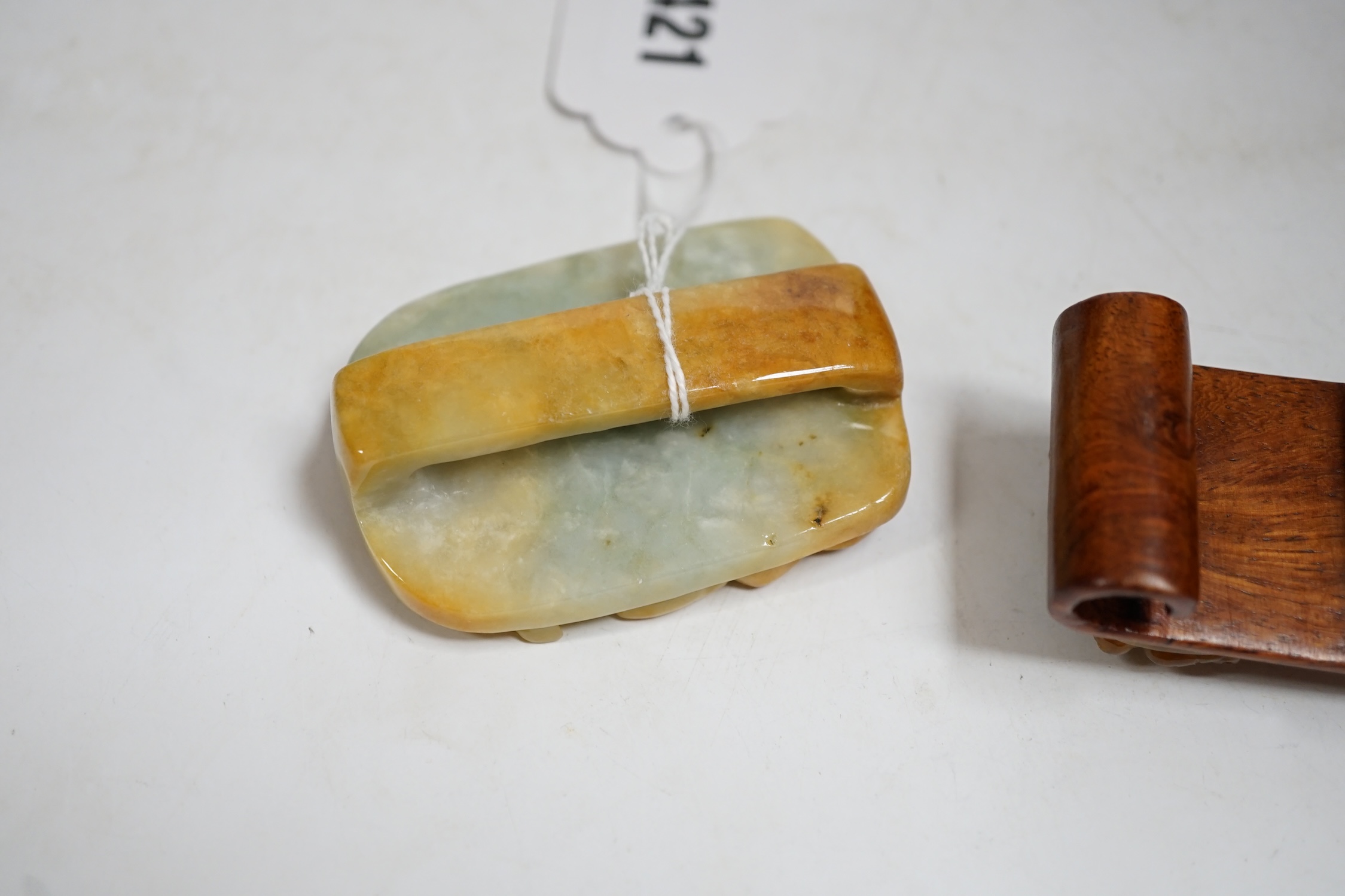 A Chinese jadeite belt buckle and a plaque carved with a dragon, largest 6.5cm high. Condition - good